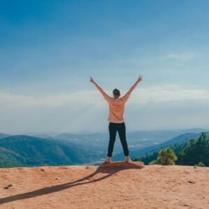 Woman Standing on Cliff